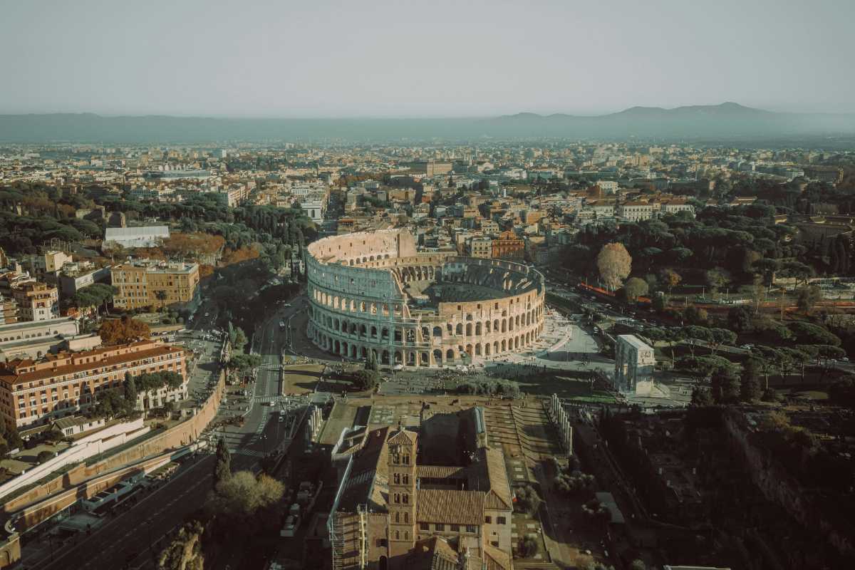 Sentiero panoramico che mostra il Colosseo sullo sfondo, immerso nella natura